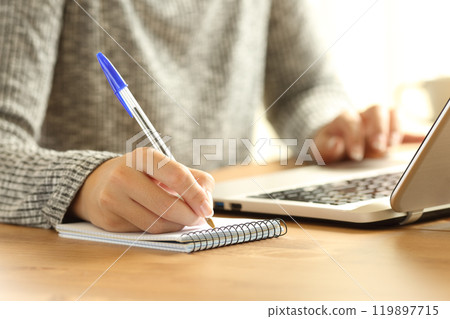 Woman hands taking notes in a notebook Woman hands taking notes in a notebook 119897715