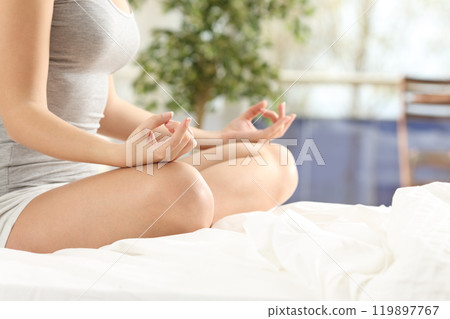 Woman practicing yoga on the bed Woman practicing yoga on the bed 119897767
