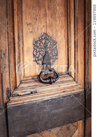 Old and weathered door knocker of a Parisian mansion Old and weathered door knocker of a Parisian mansion 119897808
