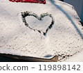 Close-up. Heart drawn in snow on the rear window of a car. 119898142