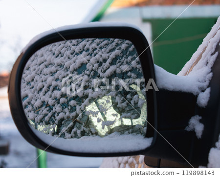 Rearview mirror of a car in the snow. Close up Rearview mirror of a car in the snow. Close up 119898143
