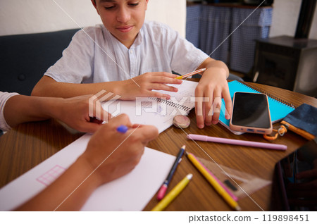 Parent helping child with homework and learning at home Parent helping child with homework and learning at home 119898451