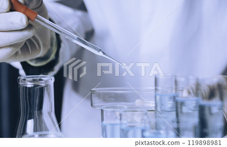 Researcher with glass laboratory chemical test tubes with liquid for analytical , medical, pharmaceutical and scientific research concept. 119898981