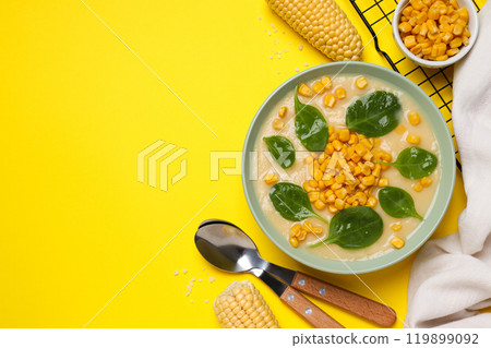 Corn soup in a plate, on a yellow background. Corn soup in a plate, on a yellow background. 119899092
