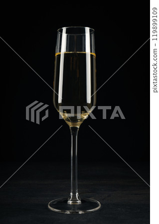 A glass of champagne on a black background A glass of champagne on a black background 119899109