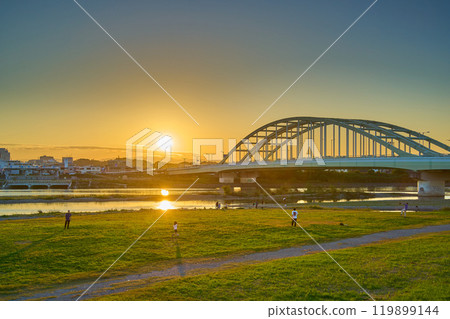 View of Tama Aqueduct and Tama Ward, Kawasaki City from the Tama River riverbed in Komae City, Tokyo on an autumn evening 119899144