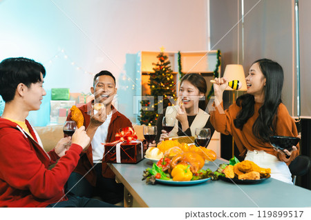 drinks and conversation, social gathering and get together at New Year young people, group and gift exchange at the event, celebration at home. 119899517