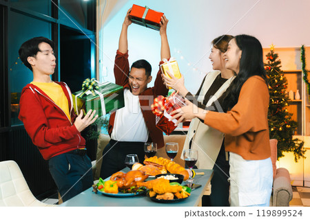 drinks and conversation, social gathering and get together at New Year young people, group and gift exchange at the event, celebration at home. 119899524