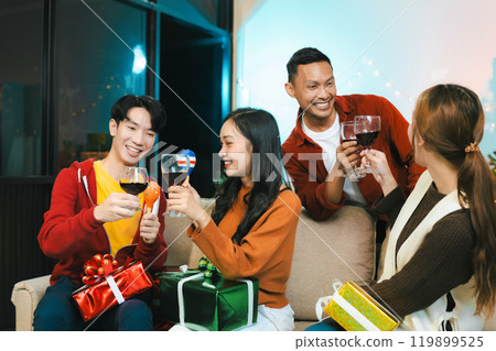 drinks and conversation, social gathering and get together at New Year young people, group and gift exchange at the event, celebration at home. 119899525