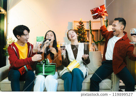 drinks and conversation, social gathering and get together at New Year young people, group and gift exchange at the event, celebration at home. drinks and conversation, social gathering and get together at New Year young people, group and gift exchange at the event, celebration at home. 119899527