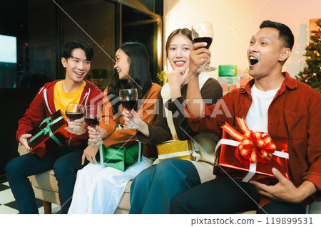 drinks and conversation, social gathering and get together at New Year young people, group and gift exchange at the event, celebration at home. 119899531