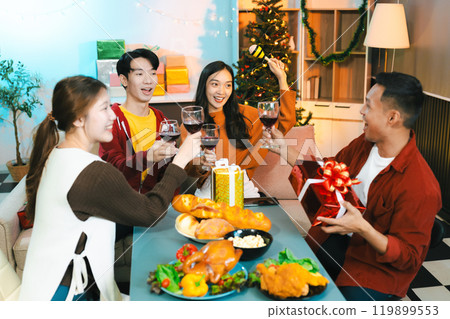 drinks and conversation, social gathering and get together at New Year young people, group and gift exchange at the event, celebration at home. 119899553