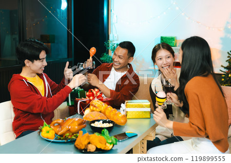 drinks and conversation, social gathering and get together at New Year young people, group and gift exchange at the event, celebration at home. 119899555