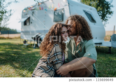 Young couple is on a camping trip in nature. Caravan traveling for young people. 119899649