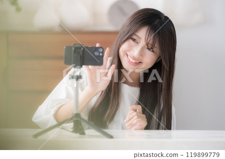 Image of a video distributor: A cute young woman waving at the camera Image of a video distributor: A cute young woman waving at the camera 119899779