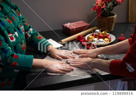 Mother and daughter baking Christmas treats together, family traditions, Christmas Eve baking, holiday warmth, festive kitchen, family bonding. 119899914
