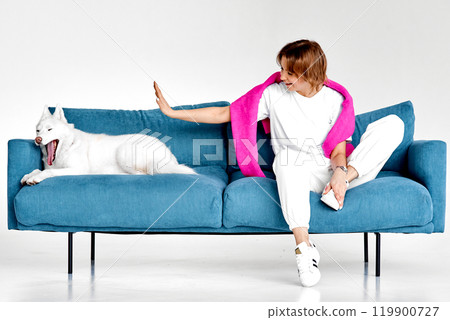 Playful Interaction Between Woman and Yawning Husky 119900727