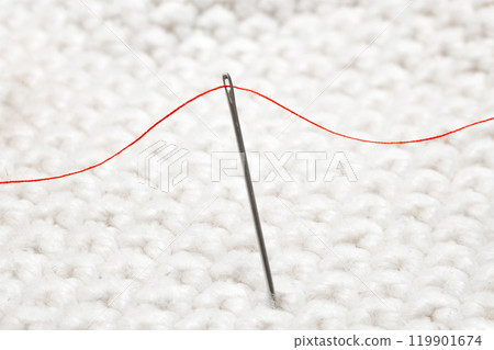 Sewing needle with red thread for sewing close-up Sewing needle with red thread for sewing close-up 119901674