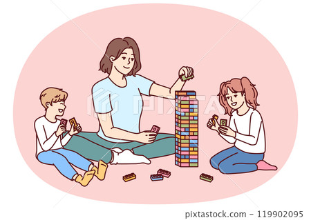 Woman babysitter with kids plays constructor building tower of children blocks in kindergarten Woman babysitter with kids plays constructor building tower of children blocks in kindergarten 119902095