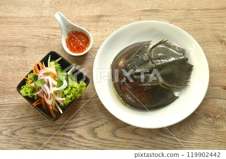 spicy and sour sea horseshoe crab egg wiith slice vegetable salad Thai food on plate 119902442