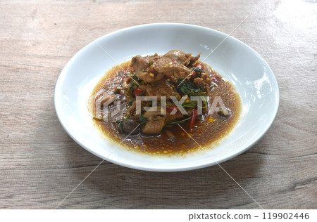 spicy chili stir-fried chicken meat and gizzard couple liver with basil leaf on plate 119902446