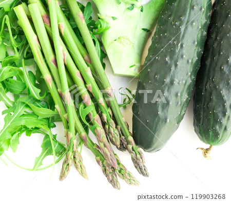 Still life from green farm vegetables, arugula, broccoli, asparagus and cucumbers on white background 119903268