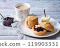 Cream tea with scones, afternoon tea, milk tea, jam on top, blue wood background 119903331
