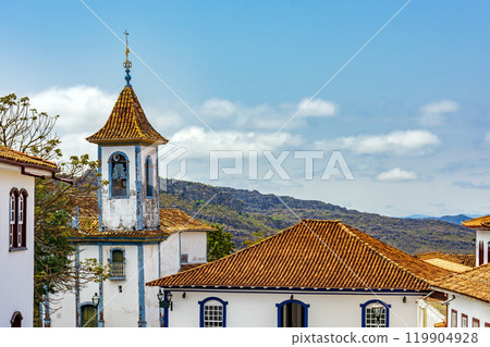 Church tower with bell and colonial houses Church tower with bell and colonial houses 119904928