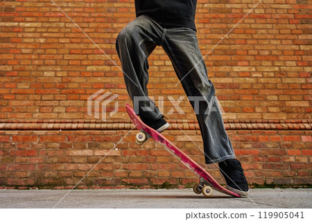 Skateboarder Performing Trick on Urban Street 119905041