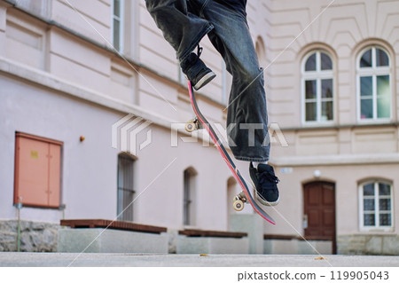 Skateboarder Performing Trick on Urban Street Skateboarder Performing Trick on Urban Street 119905043