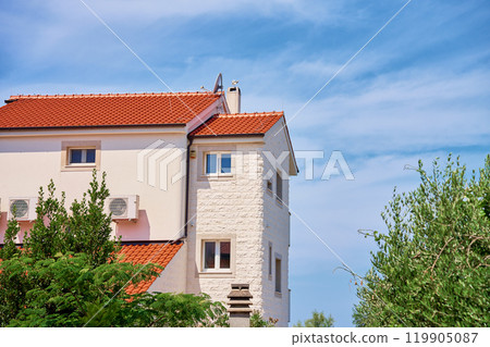 Traditional Mediterranean house with red tile roof at summer day 119905087