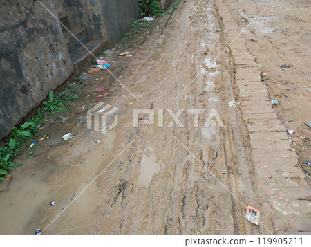 dirty and muddy road in rural village of India dirty and muddy road in rural village of India 119905211