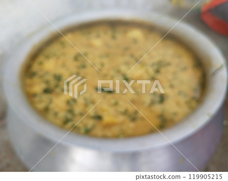 blurry image of khichdi. making khichdi in very heavy and huge pot for many peoples in village family. Dal Khichdi, a wholesome Indian comfort meal. creamy lentil and rice dish, 119905215