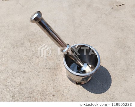 iron mortar with pestle, iron grinder making paste from spice ingredients 119905228