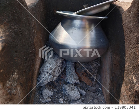 boiling milk inside muddy stove. Rural kitchen. Traditional stoves used by residents in rural India, pakistan, Bangladesh, nepal, afganistan, Sri Lanka and undeveloped countries. made of clay, fueled 119905341