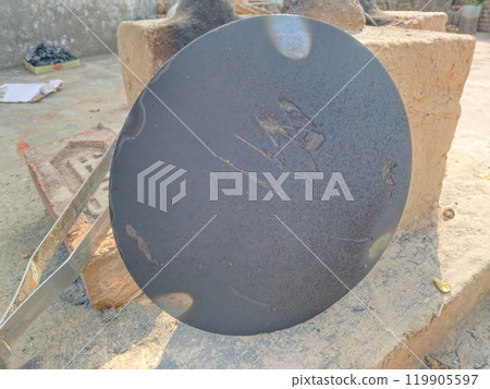 roti maker tawa stand besides rural kitchen. Traditional stoves used by residents in rural India, pakistan, Bangladesh, nepal, afganistan, Sri Lanka and undeveloped countries. made of clay, fueled roti maker tawa stand besides rural kitchen. Traditional stoves used by residents in rural India, pakistan, Bangladesh, nepal, afganistan, Sri Lanka and undeveloped countries. made of clay, fueled 119905597