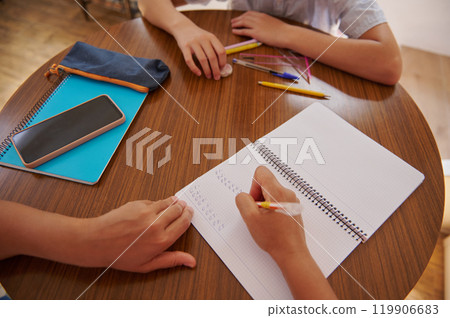 Students studying together with notebooks and stationery on a table 119906683