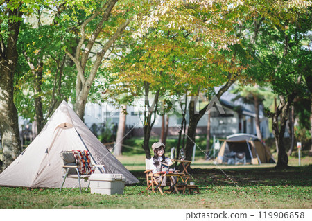 A woman enjoying outdoors at a campsite 119906858
