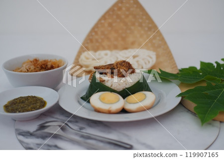 rice with meat, egg, crackers, sambal and noodles on a marble table 119907165