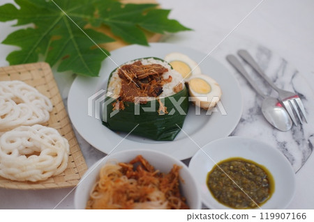 rice with meat, egg, crackers, sambal and noodles on a marble table rice with meat, egg, crackers, sambal and noodles on a marble table 119907166
