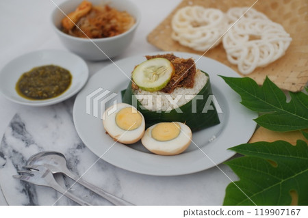 rice with meat, egg, crackers, sambal and noodles on a marble table 119907167