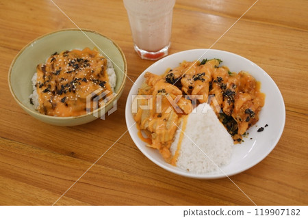 Rice topped with black sesame seeds and dried tomatoes in a bowl Rice topped with black sesame seeds and dried tomatoes in a bowl 119907182