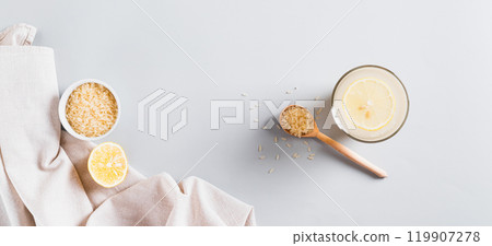 Trendy rice and lemon drink to reduce appetite in a glass on the table top view web banner 119907278