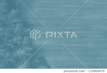 Blue background with a fir branch on a wooden panel Blue background with a fir branch on a wooden panel 119908479