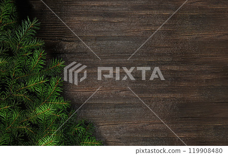 Christmas card with a fir branch on a wooden background 119908480
