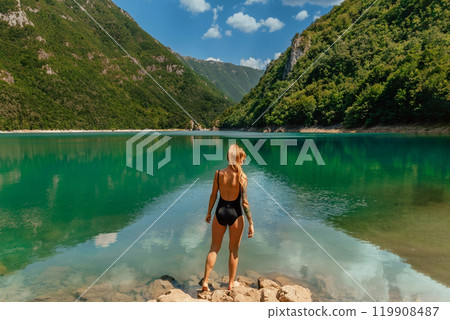 Woman in Swimsuit on Nature Background with Mountain Lake Woman in Swimsuit on Nature Background with Mountain Lake 119908487