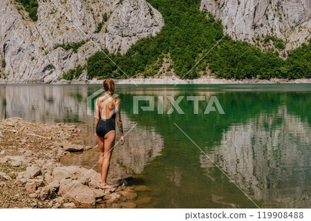 Woman in Swimsuit on Nature Background with Mountain Lake 119908488