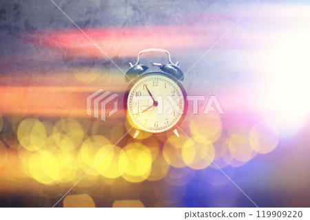 Background with a clock on the table and bokeh in pastel rainbow colors. Time for rest and travel. Background with a clock on the table and bokeh in pastel rainbow colors. Time for rest and travel. 119909220