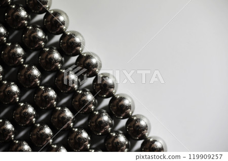 magnetic ball bearing tiling in perfect hexagonal grid. Metal balls close up. Balls of neodymium (magnets). magnetic ball bearing tiling in perfect hexagonal grid. Metal balls close up. Balls of neodymium (magnets). 119909257