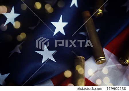 Award to the allies in the second world war.Many bullets cartridges and medals on United States flag. Concept of war glory victory. Award to the allies in the second world war.Many bullets cartridges and medals on United States flag. Concept of war glory victory. 119909288
